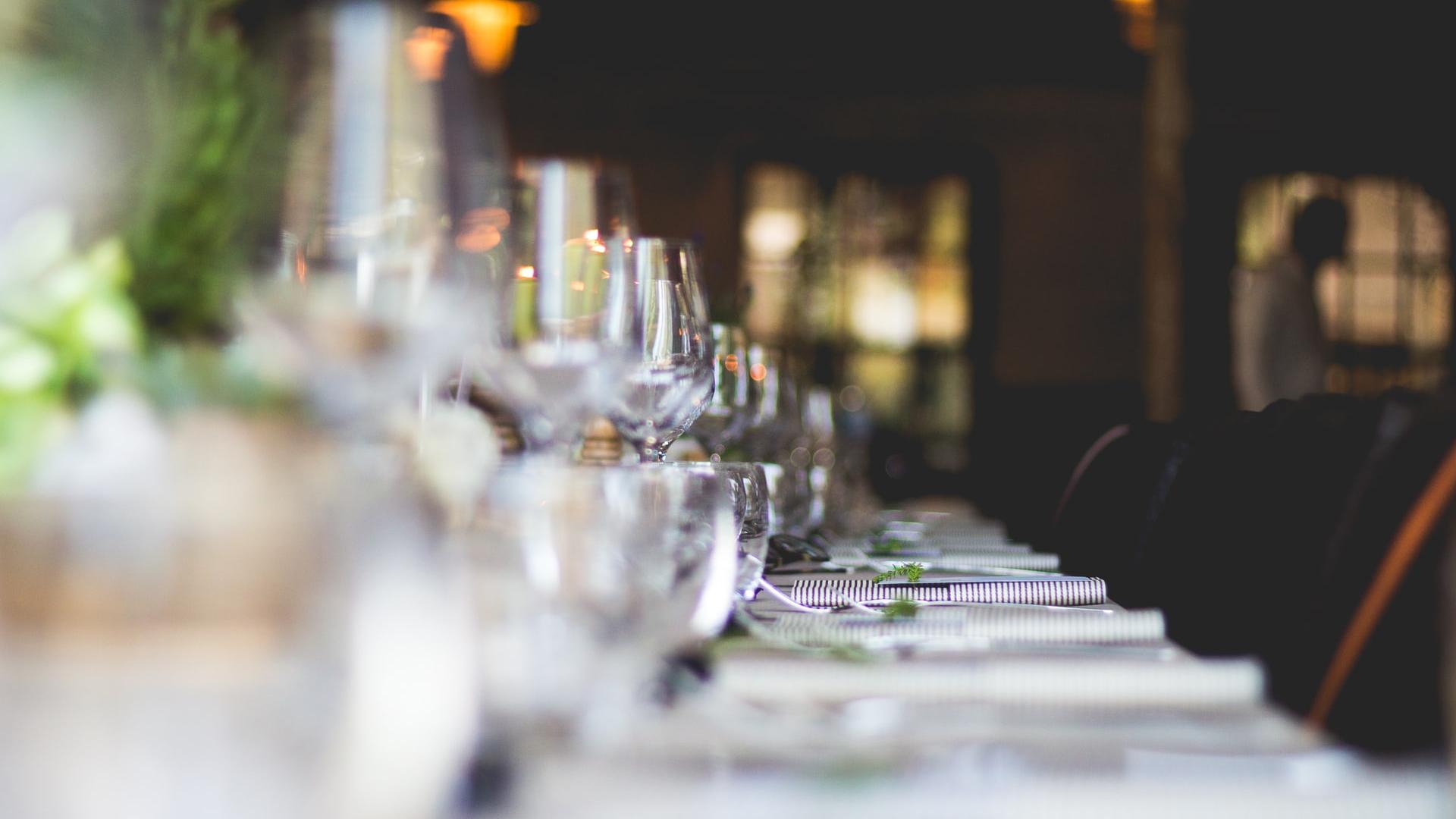 focused photo of wine glasses lined on table